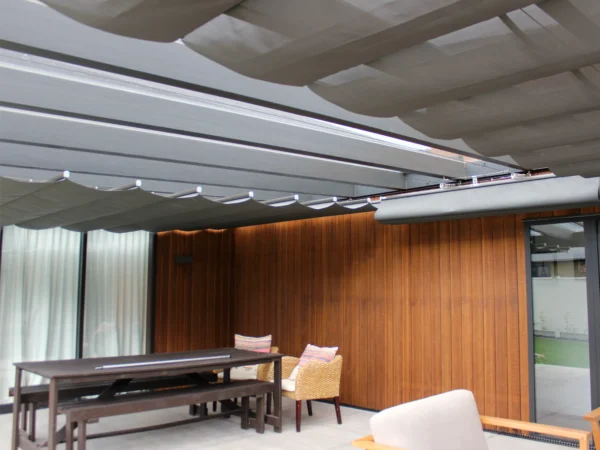 Wave shade retractable canopy installed over an alfresco dining area