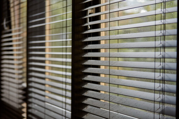 Modern wooden venetian blinds filtering light in a meeting room